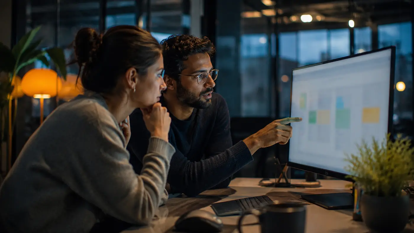 Two Teknora engineers reviewing work together at a screen